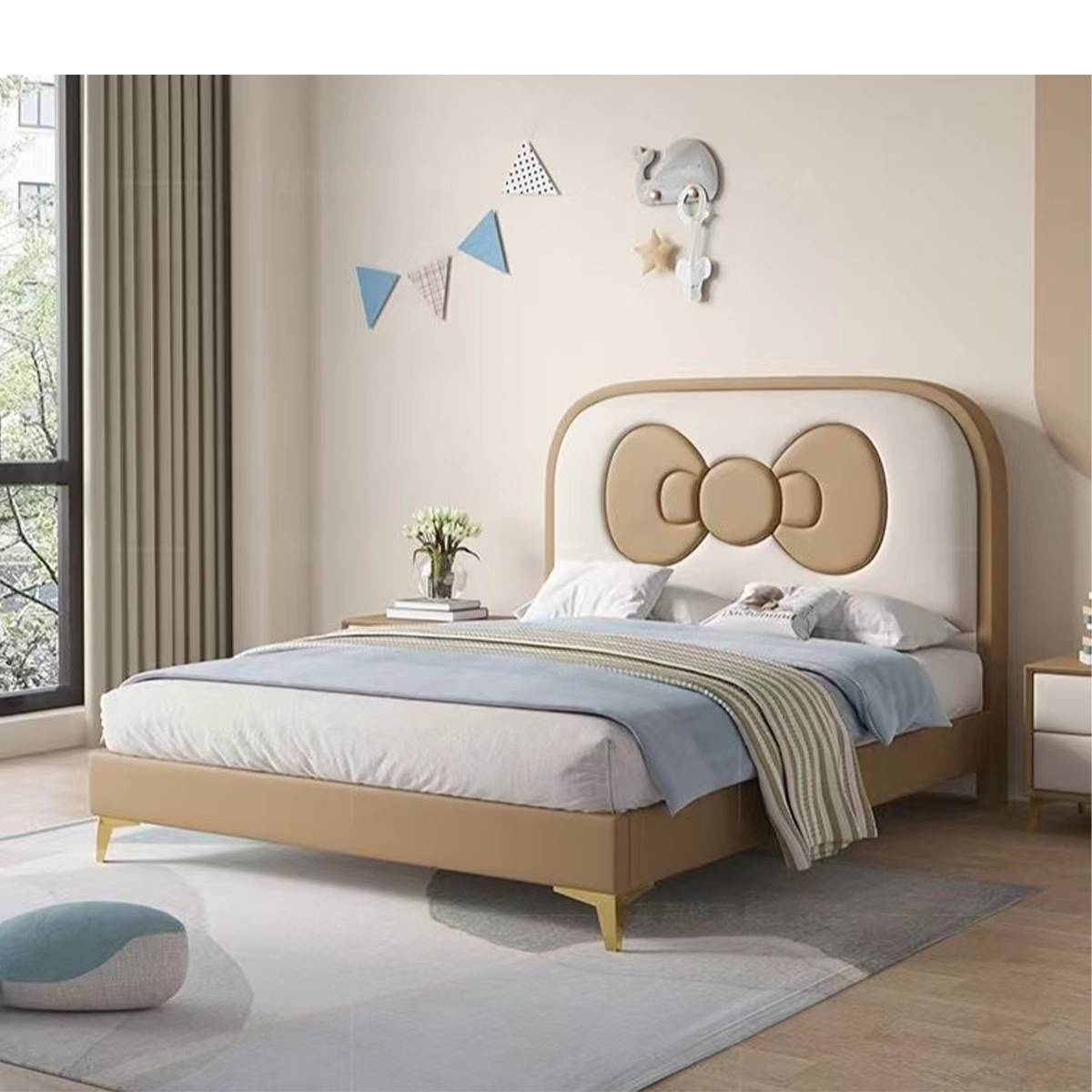 Beige and white children's bed with a large bow headboard in a neutral bedroom