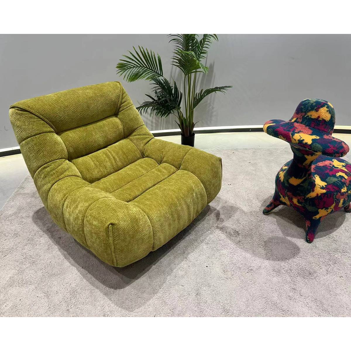 Green plush fabric swivel lounge chair angled view