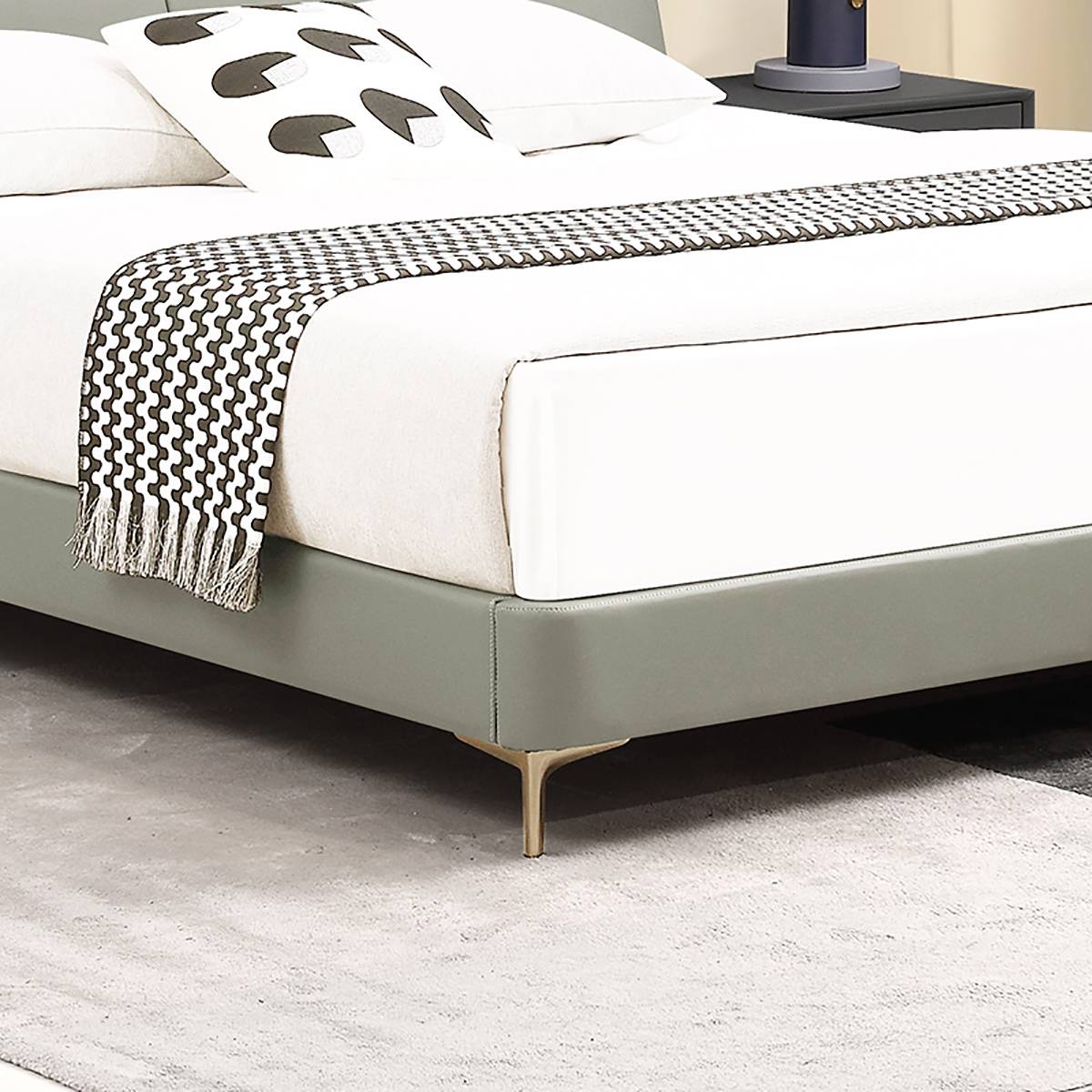 Detail shot of the bed frame base and gold metal legs