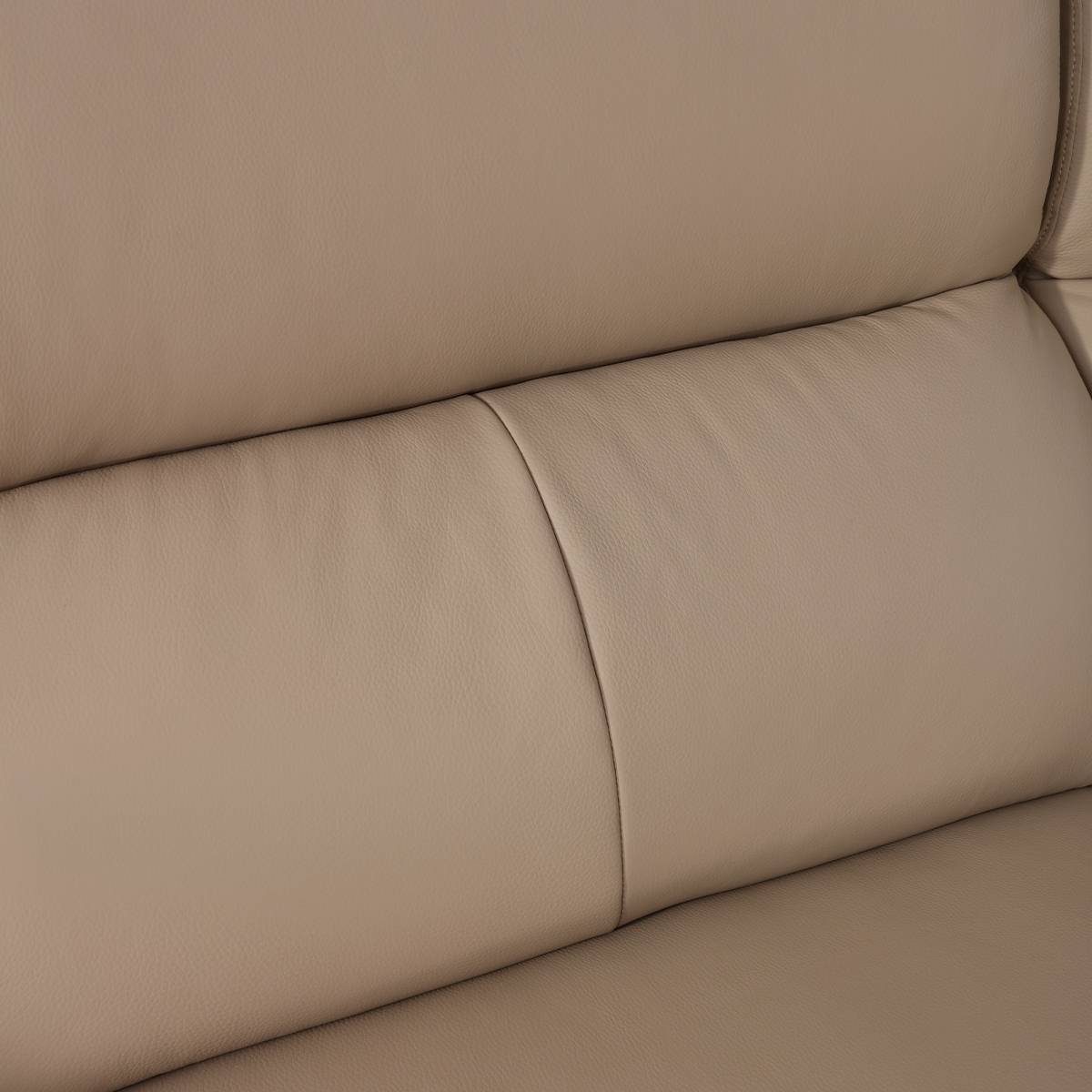 Close-up of beige leather sofa backrest