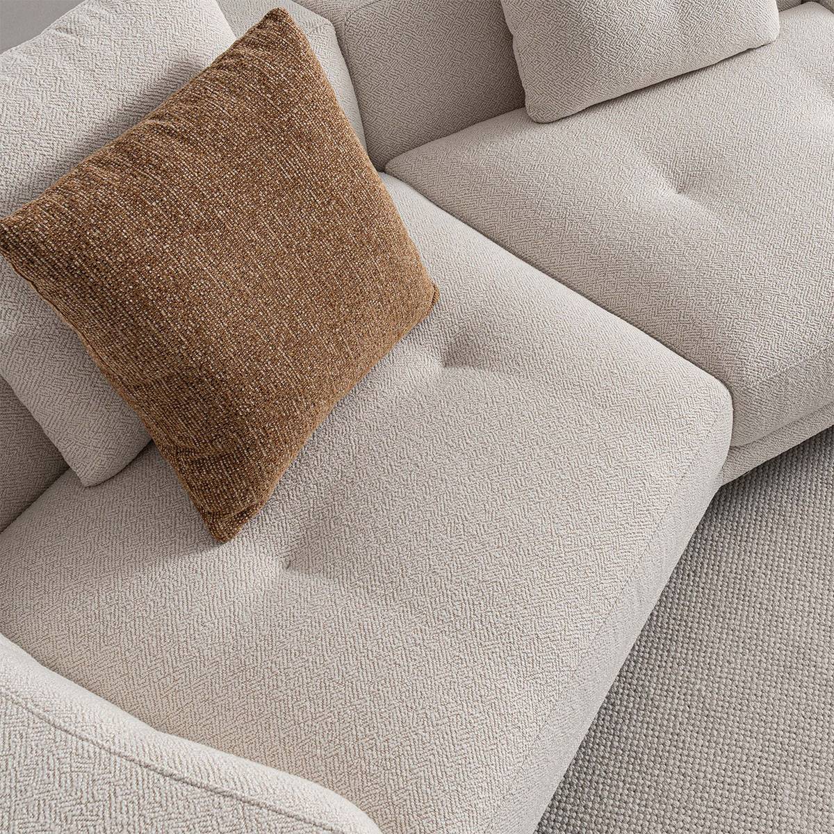 Close-up detail of the sofa fabric texture and throw pillow