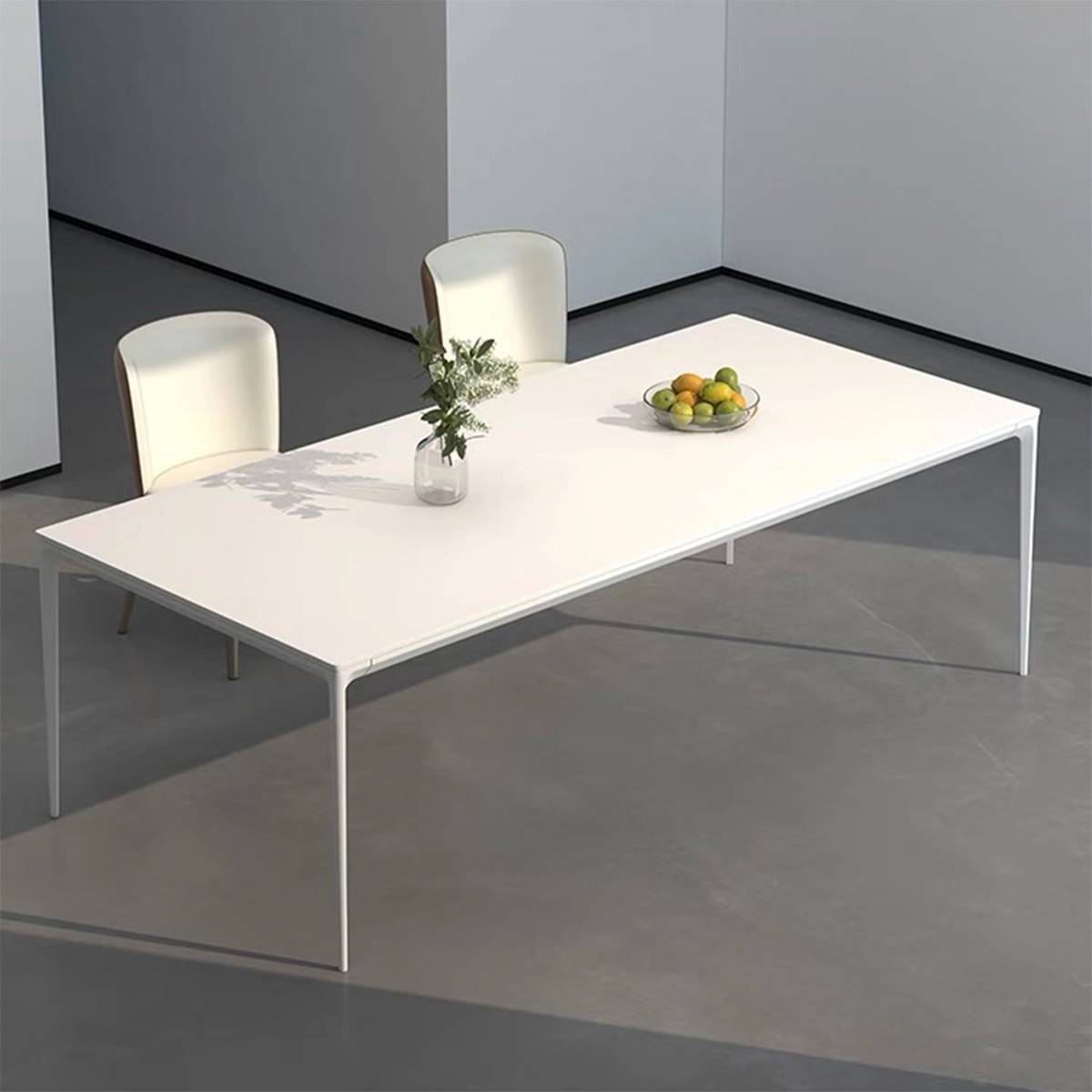 White dining table with curved legs and fruit bowl