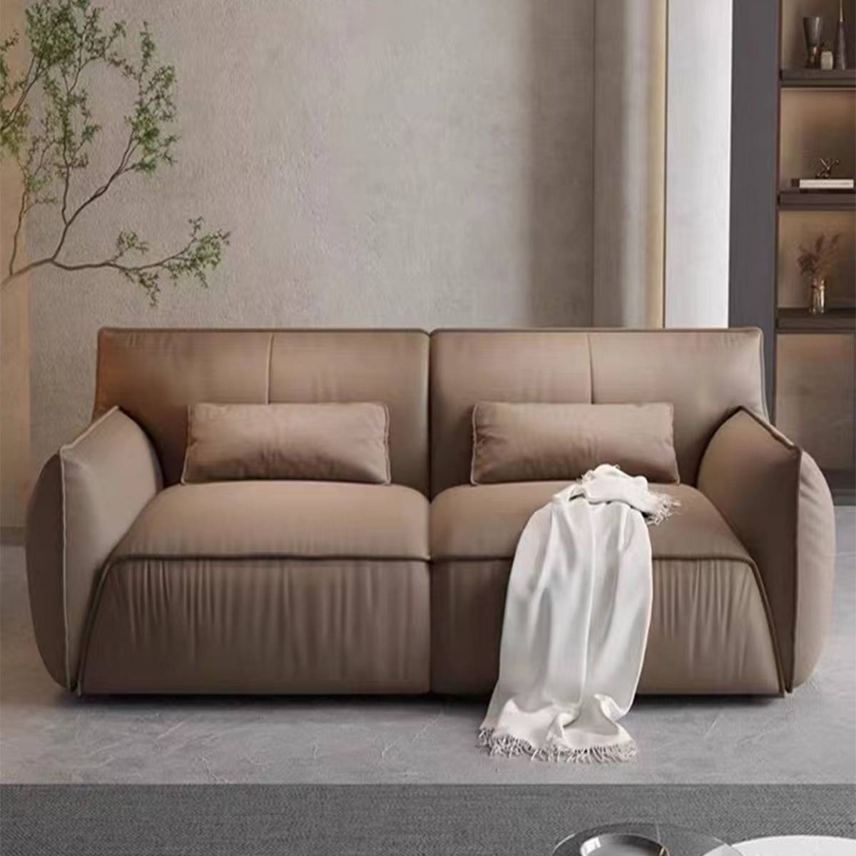 Front view of a beige eco-leather sofa with a white throw blanket draped over the seat