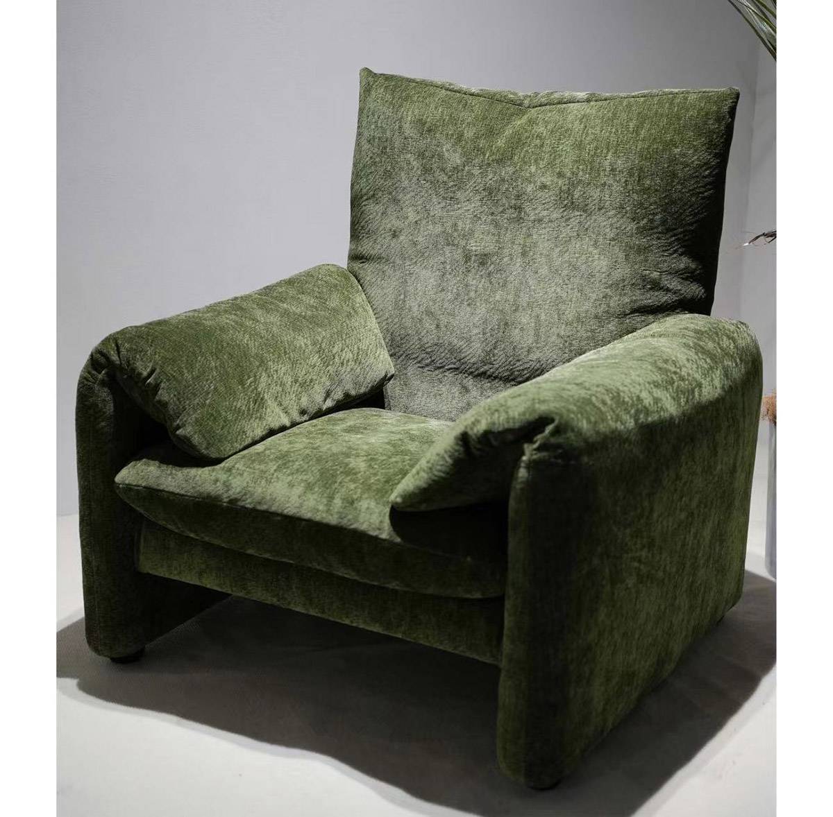 Side view of green velvet lounge chair
