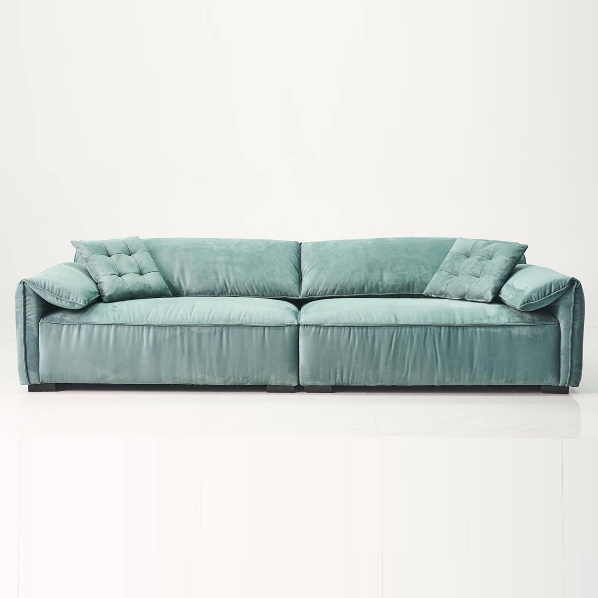 Front view of the teal B12 Elephant Ear sofa showing the tufted back cushions and rolled arms