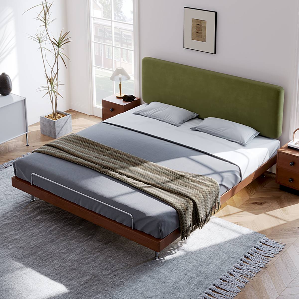 High angle view of the bed in a bedroom setting with a rug and bedside table