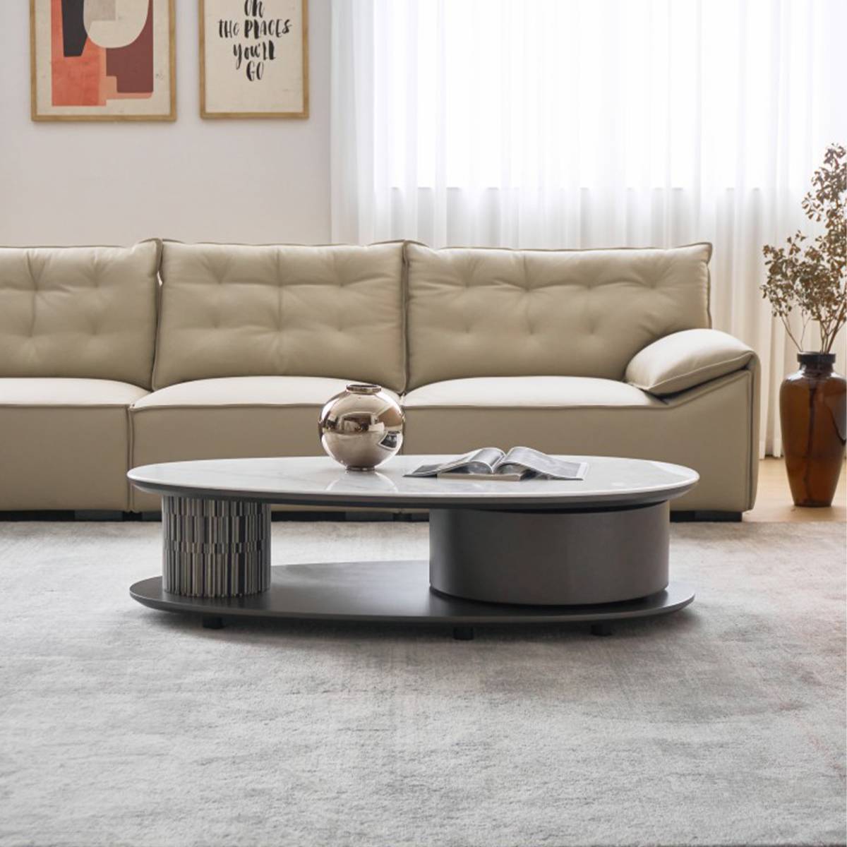 Front view of the coffee table showing the cylindrical base and lower shelf.