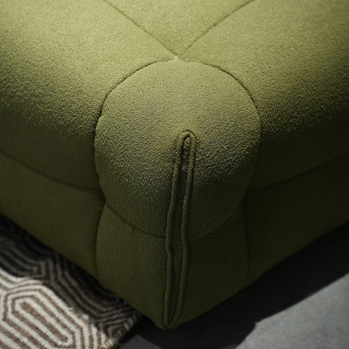 Detail shot of the tufted corner and armrest stitching