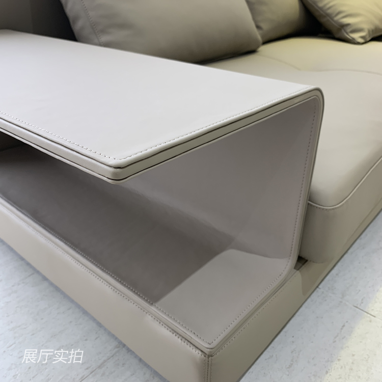 Close-up detail of the sofa's integrated side table and stitching