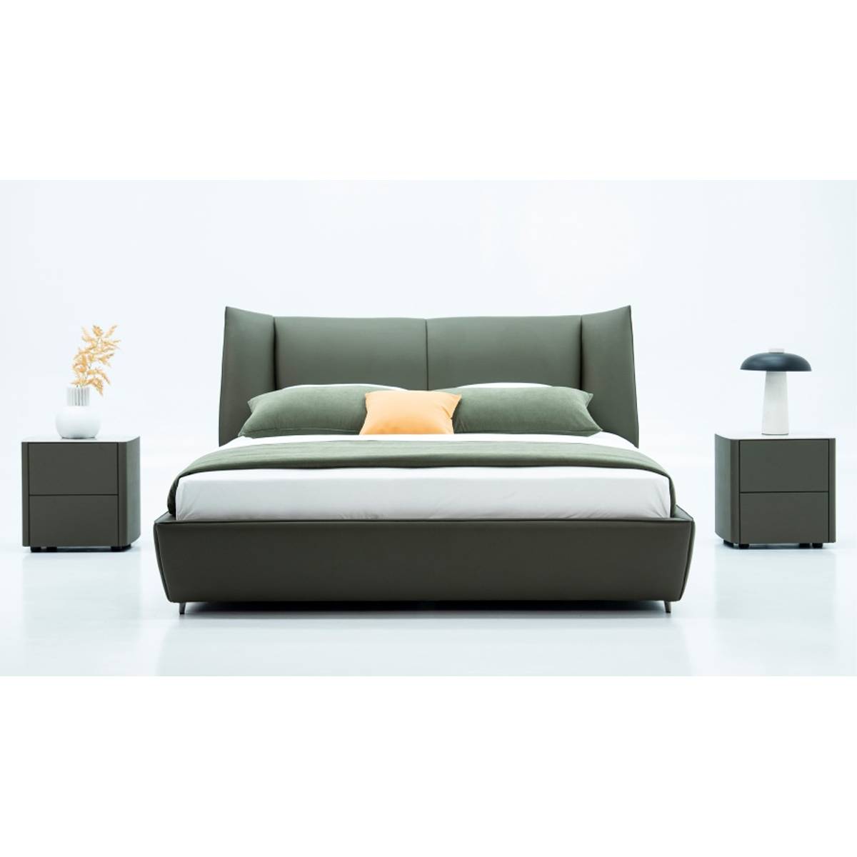 Front view of the olive green leather soft bed with pillows and throw