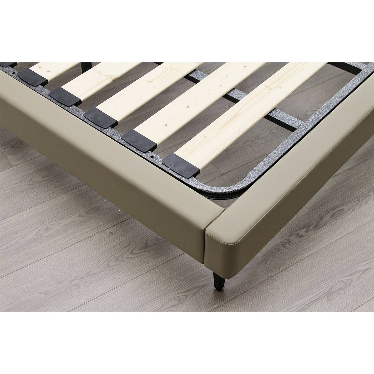 Close-up view of the bed frame showing the wooden slats and khaki leather upholstery