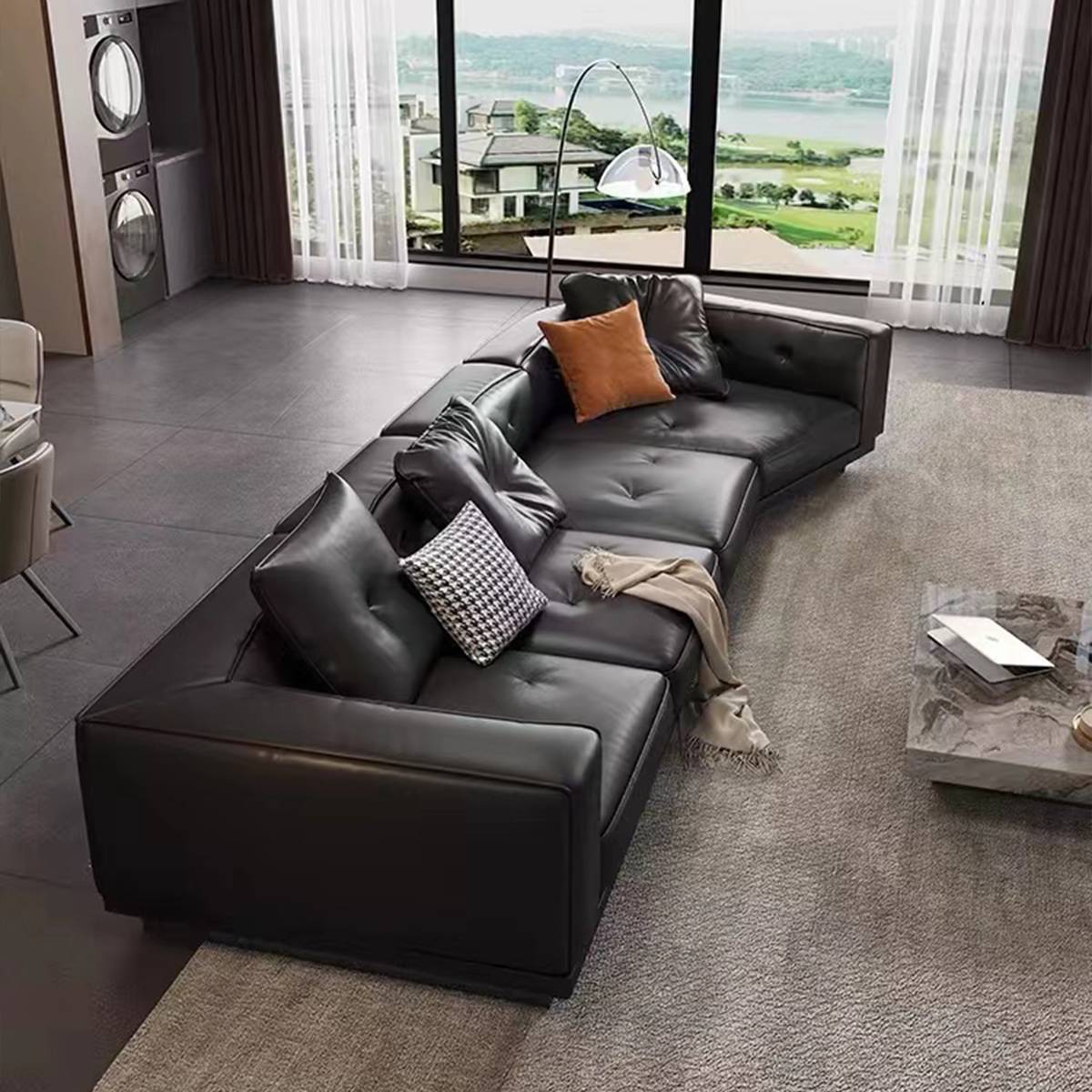High angle view of the black leather sofa with throw pillows and blanket