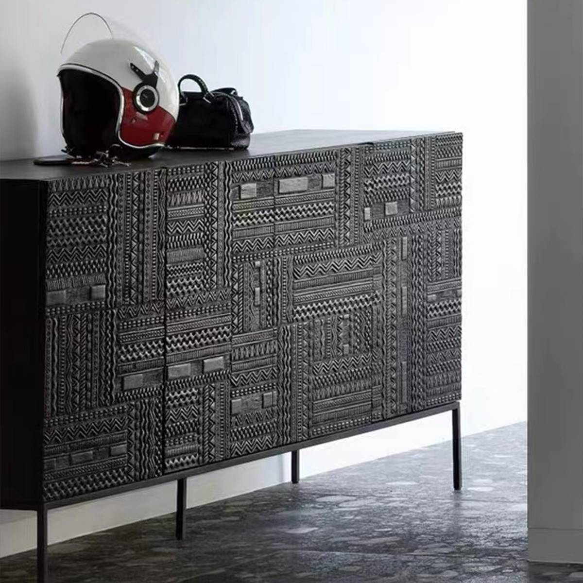 Sideboard styled with a motorcycle helmet and bag