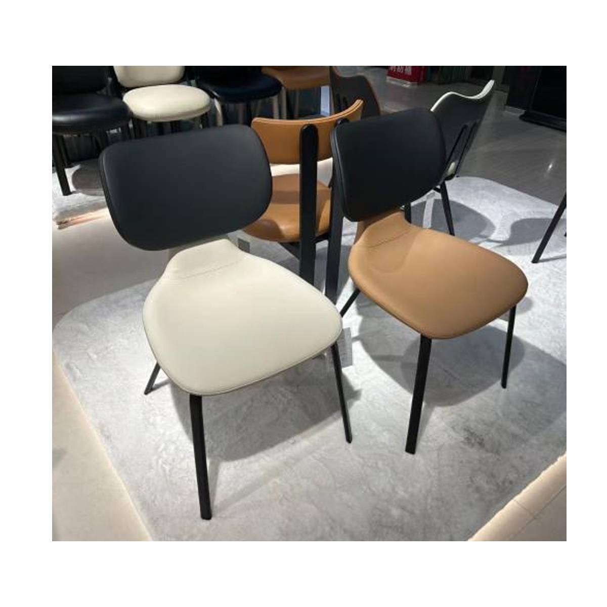 Multiple dining chairs displayed in a showroom setting