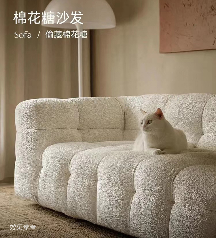Close-up of white tufted sofa with a cat sitting on it