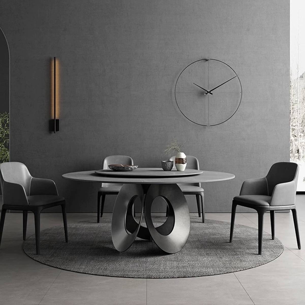Grey round dining table in a modern dining room setting