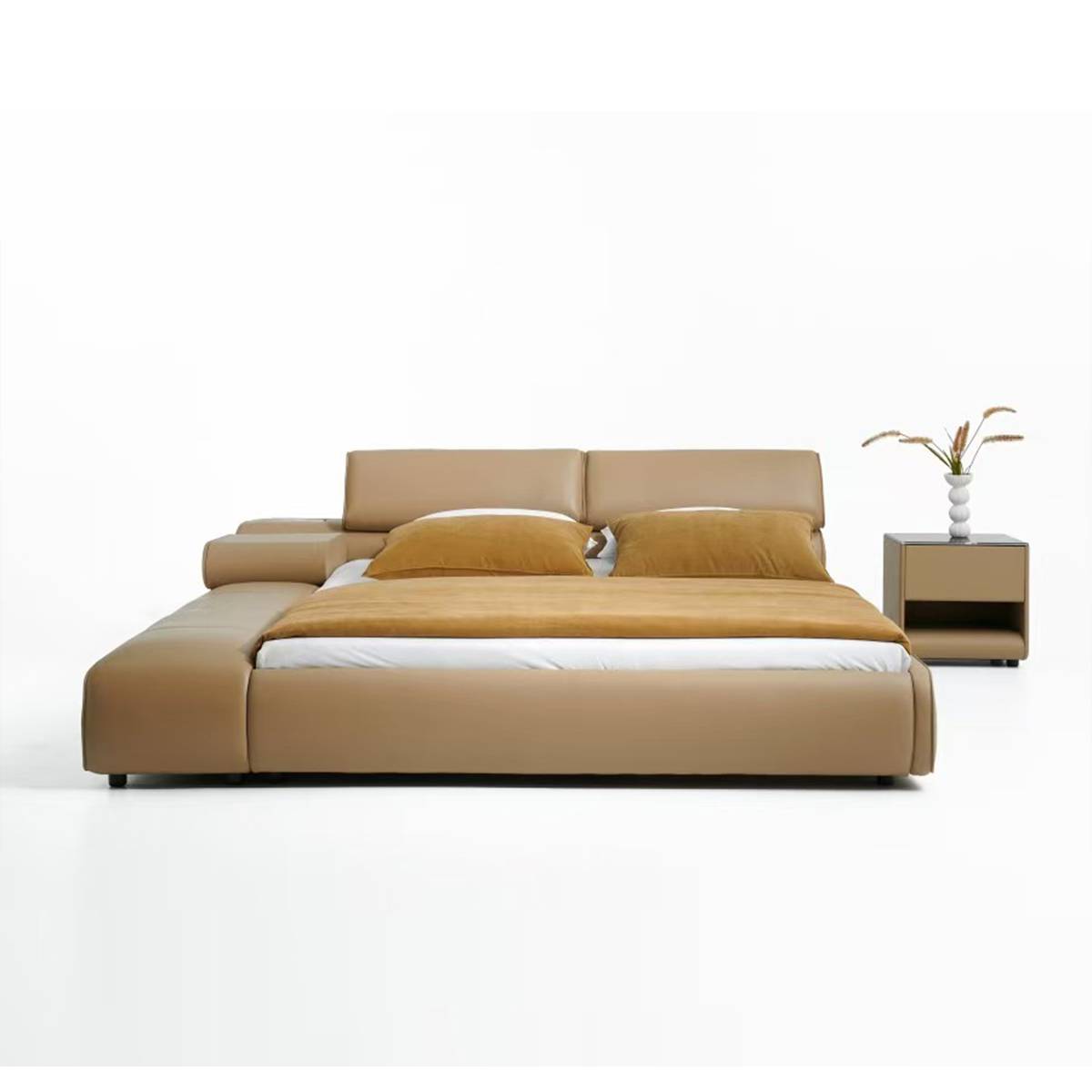 Front view of the beige leather bed with integrated chaise lounge and mustard bedding