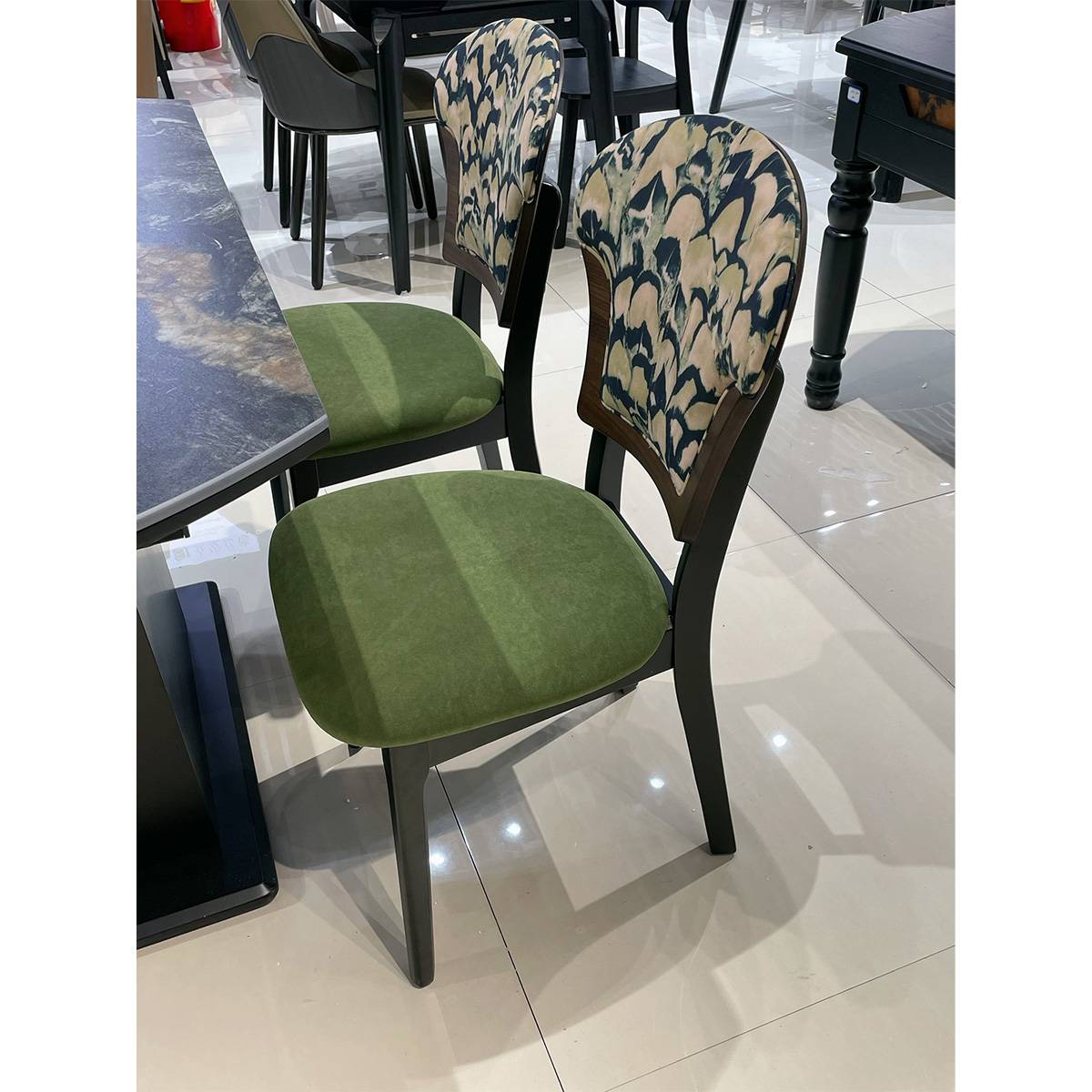 Dining chair with green velvet seat and patterned backrest