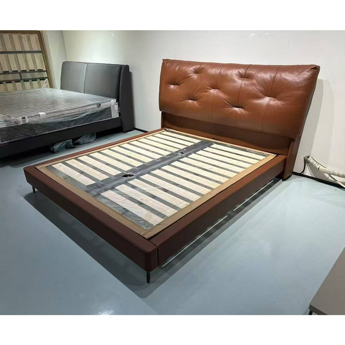 Side view of the leather bed frame showing wooden slats