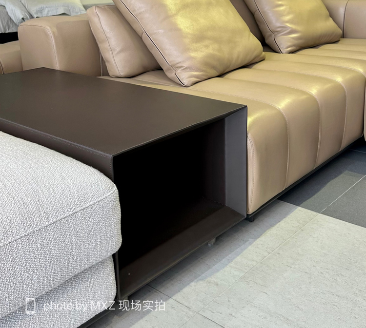 Detail of the dark brown side table attached to the sofa
