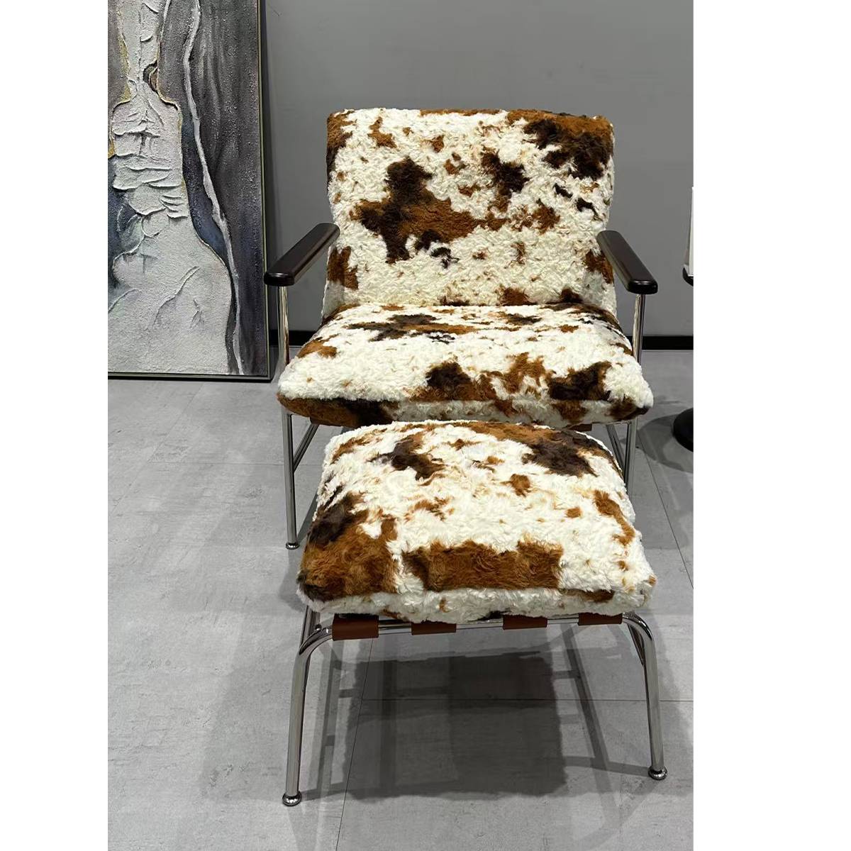 Front view of cowhide pattern lounge chair and ottoman