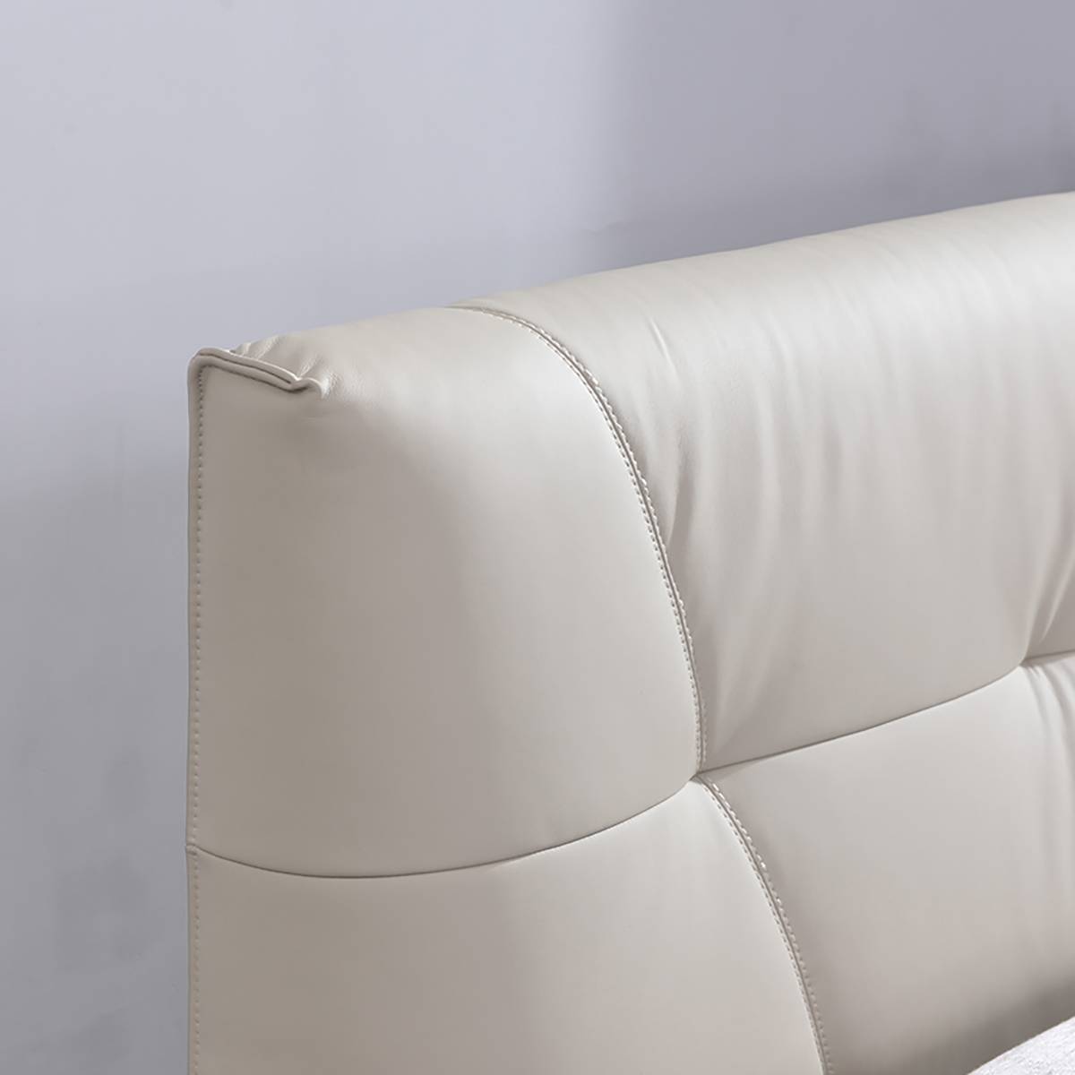 Detail shot of the tufted leather headboard stitching