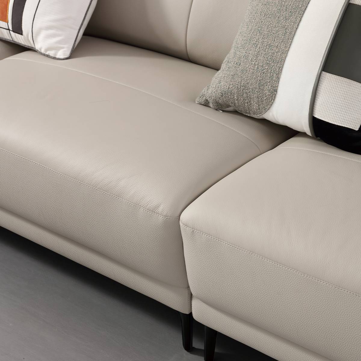 Close-up view of the sofa seat cushion and armrest showing leather texture