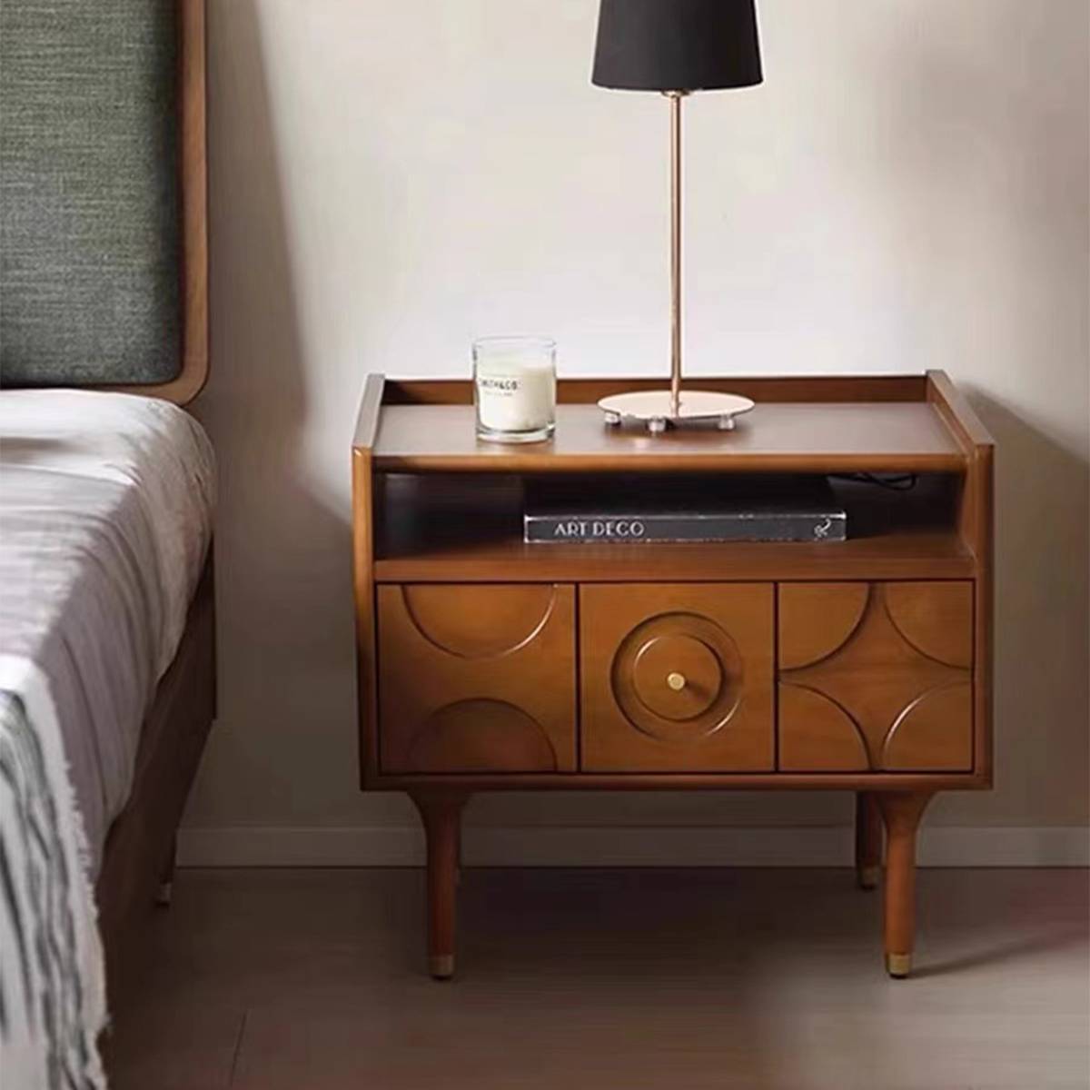 Close-up of the bedside table with the drawer open showing storage space