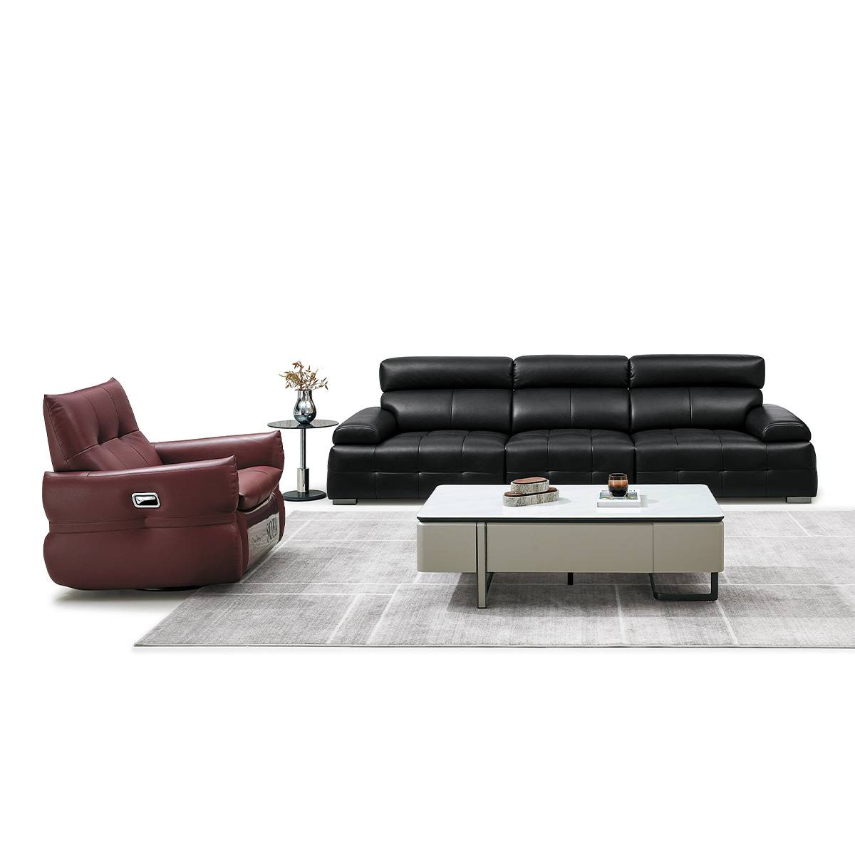 Front view of the black leather sofa and matching burgundy recliner on a white background