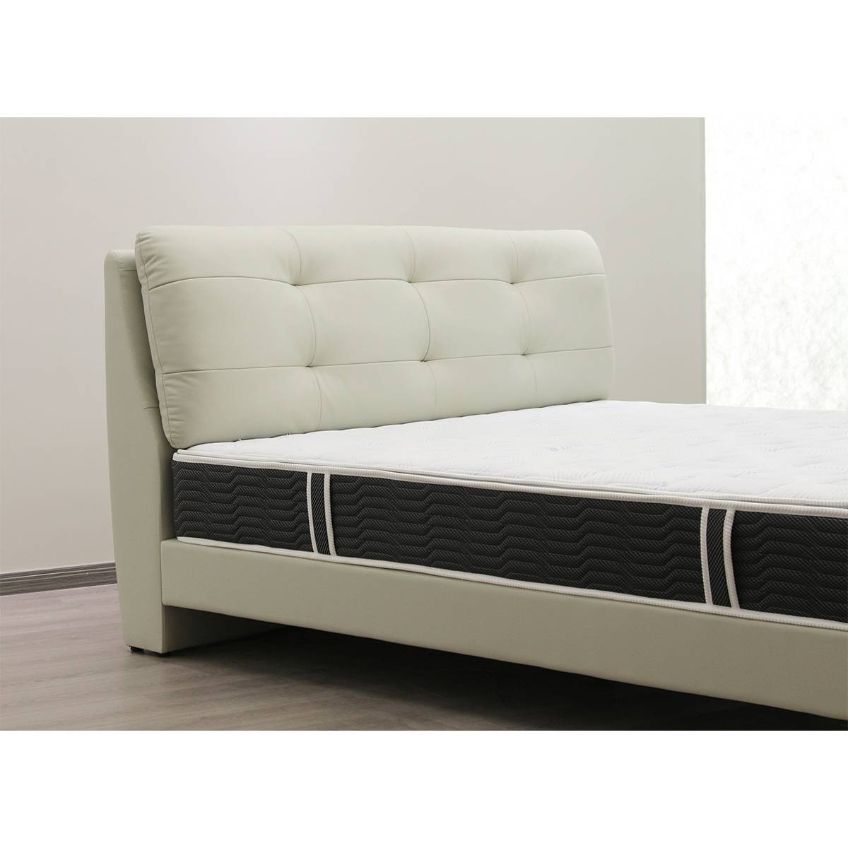 Close-up of the tufted headboard and mattress side