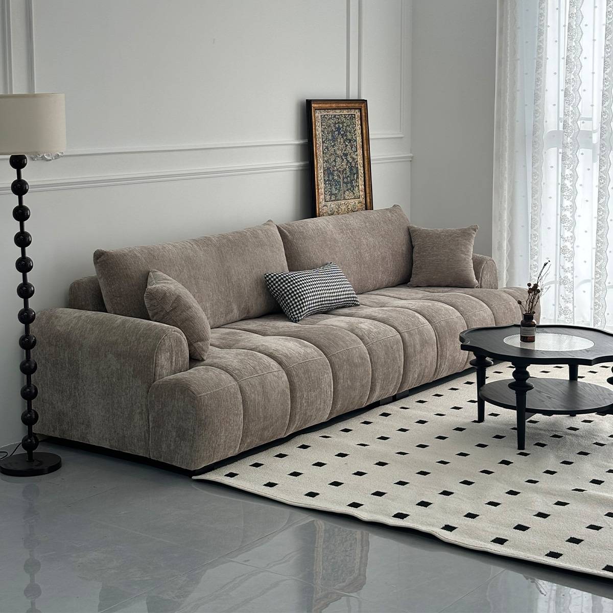 Beige fabric tufted straight sofa with a black coffee table