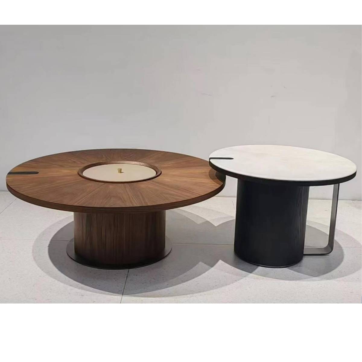 Studio shot of the two round coffee tables against a white background showing the wood and stone textures.