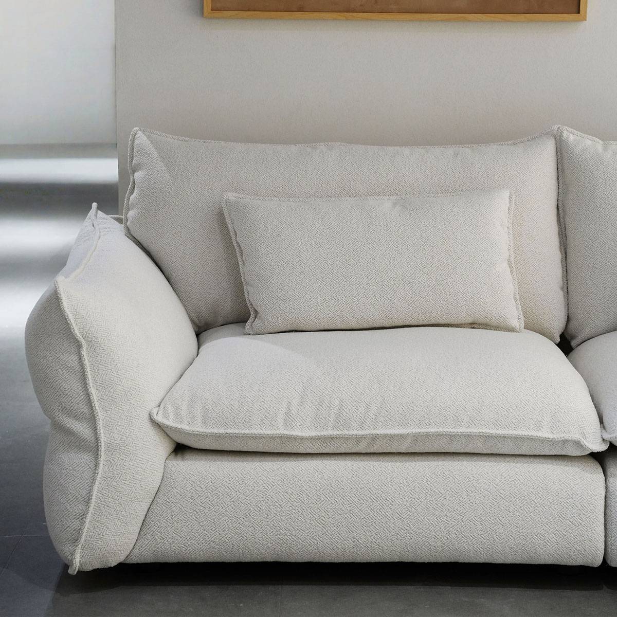 Close-up detail of the sofa's armrest and cushion texture.