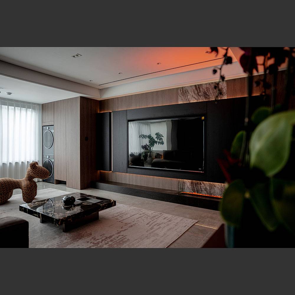 Living room view featuring a marble coffee table and TV wall