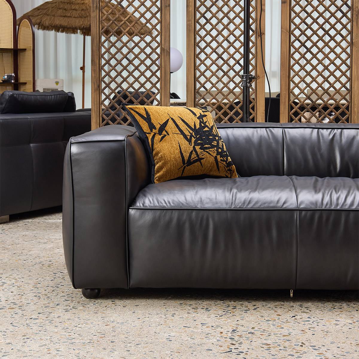Close-up detail of the leather texture and armrest in a showroom setting