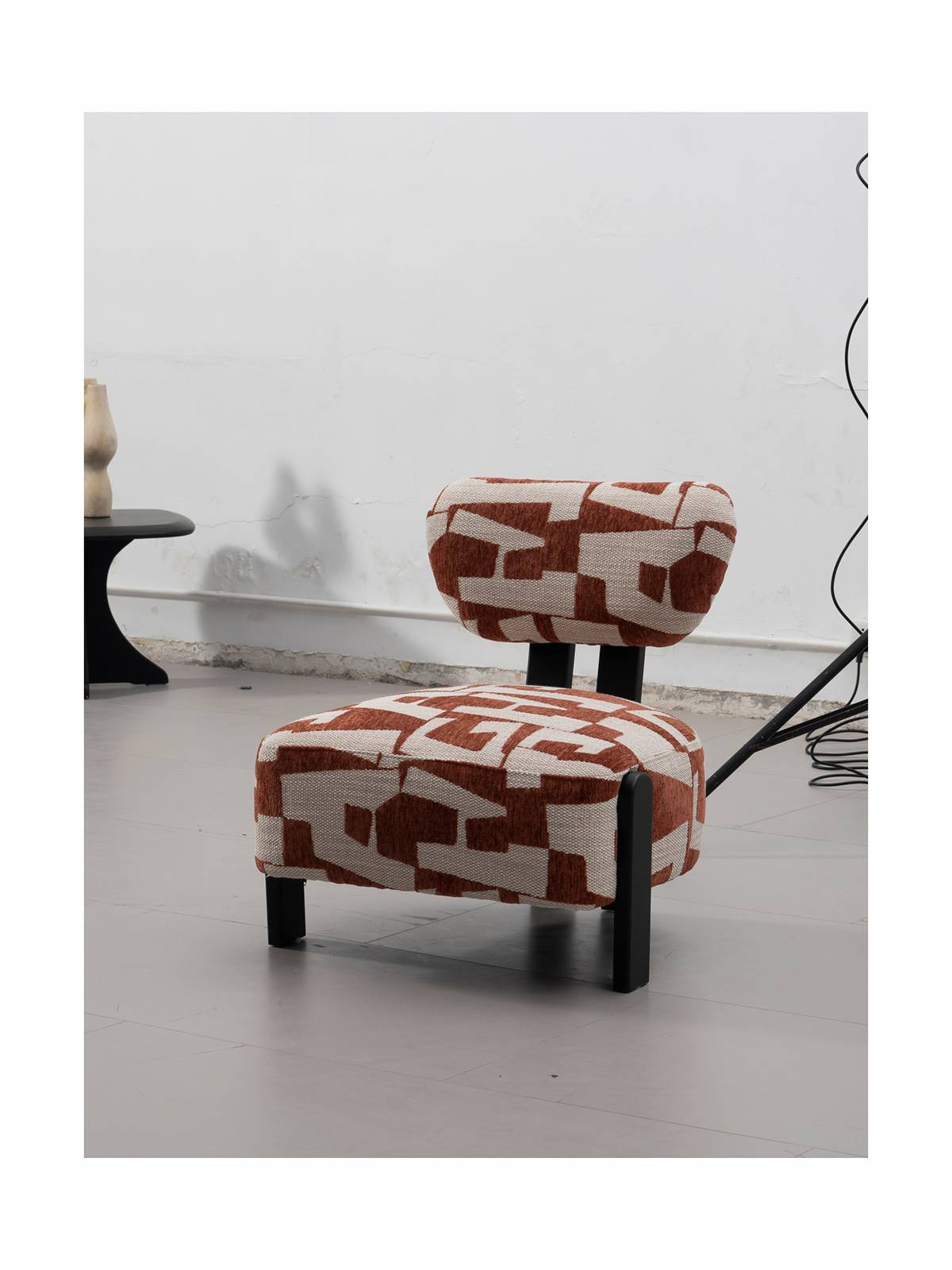 Side view of the brown geometric pattern accent chair in a room setting