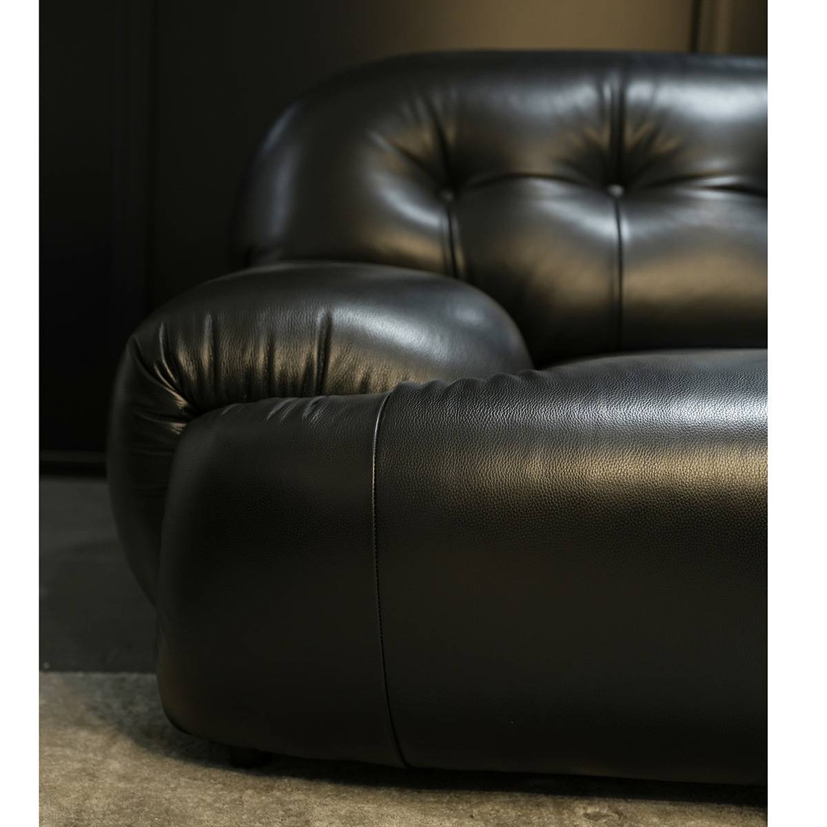 Front view of black tufted leather sofa