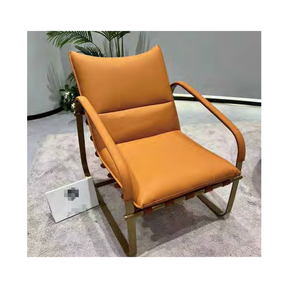 Orange velvet lounge chair with gold metal frame