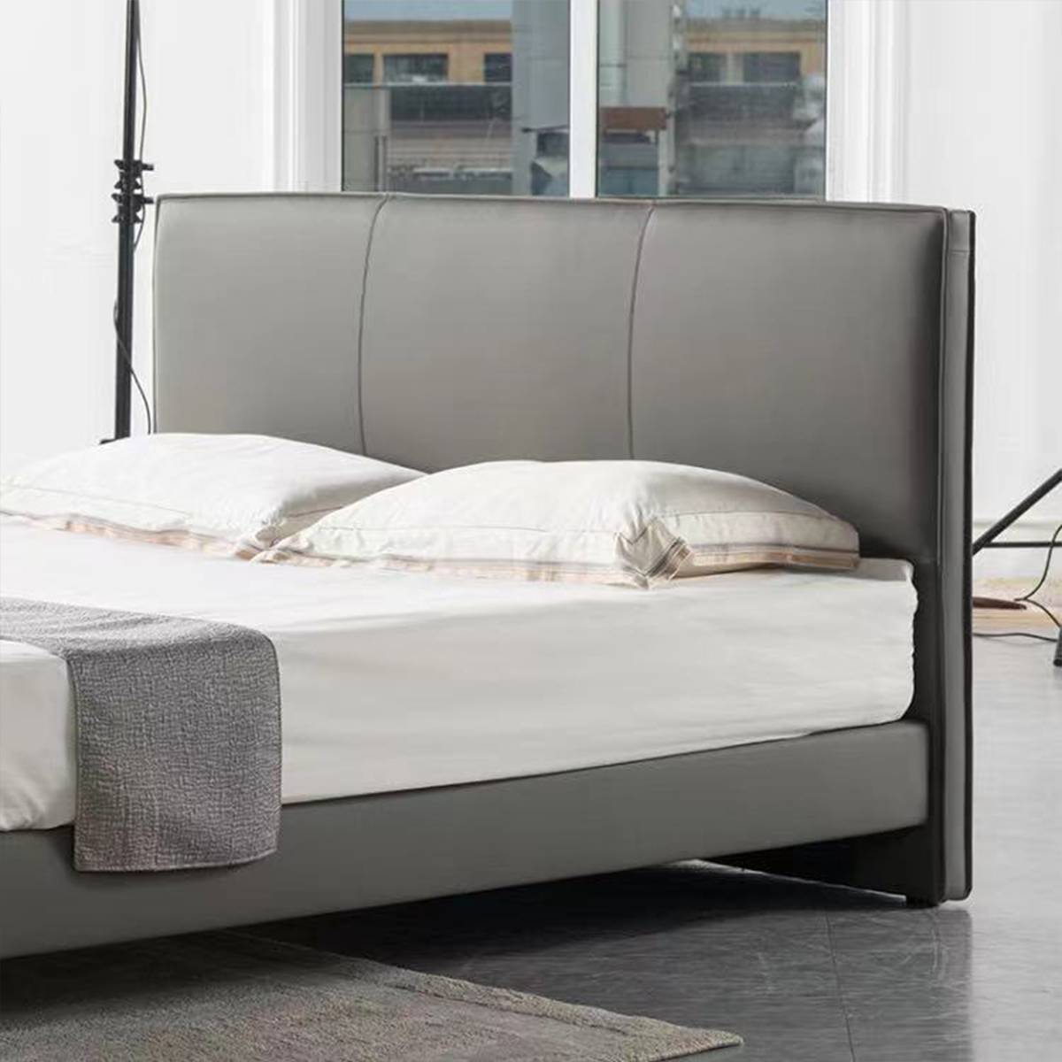 Close-up view of the bed headboard and pillows in a room setting