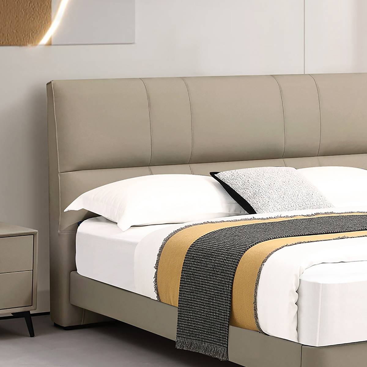Close-up of the tufted headboard and pillows on the Cheers bed