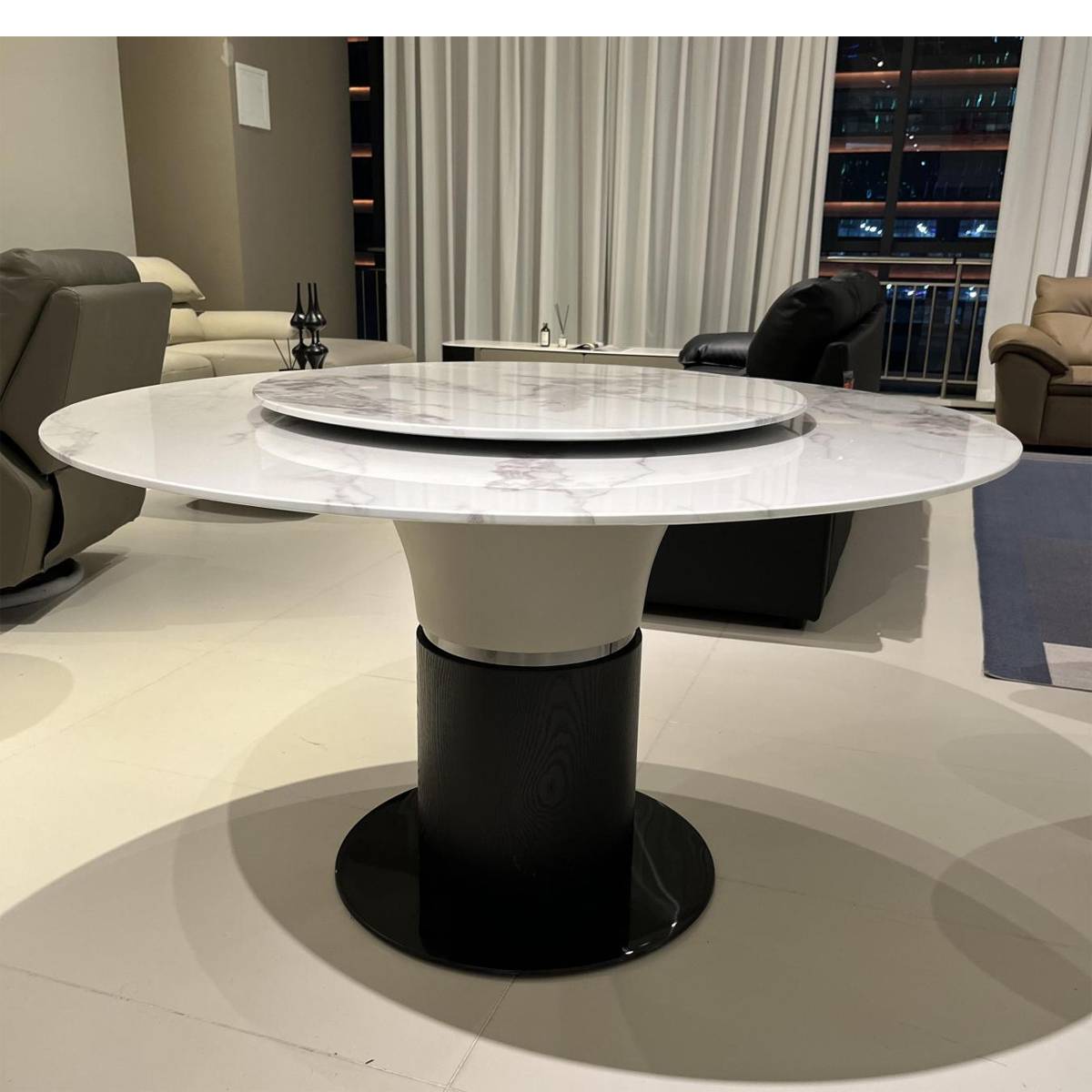 Another angle of the round dining table in a showroom setting