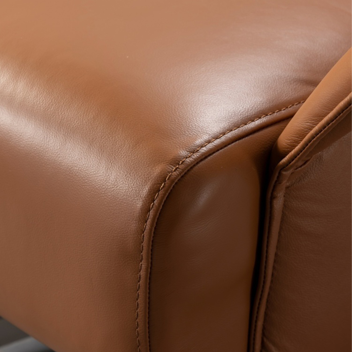 Close-up detail of the leather stitching and texture on the armrest