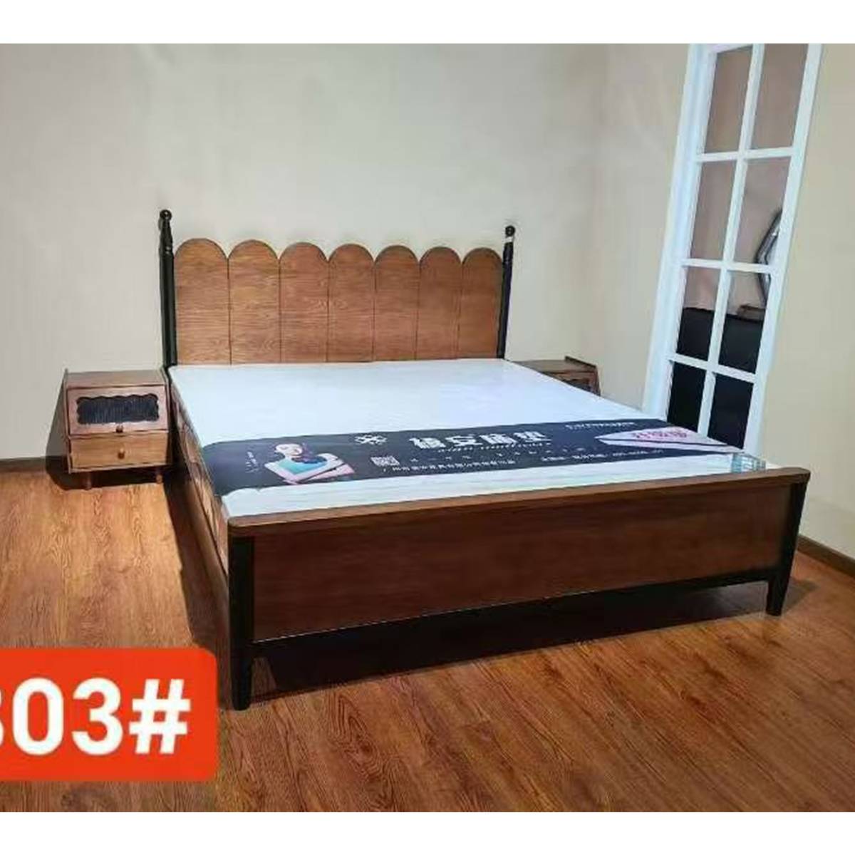 Bed with mattress and bedside table in a room setting