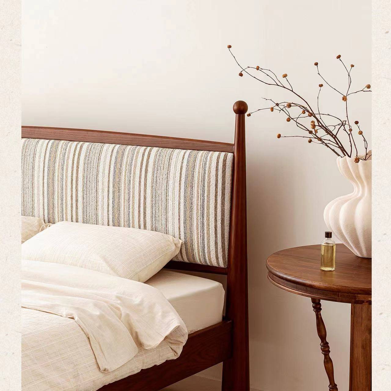 Close-up of the bed headboard showing striped fabric upholstery and wooden frame details