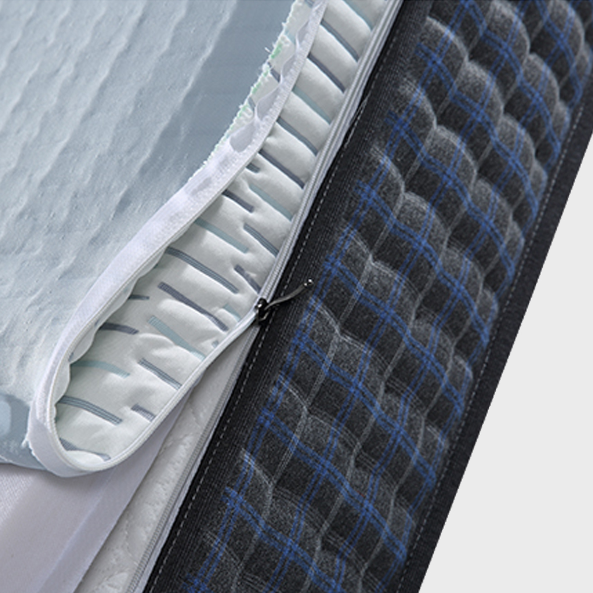 Close-up of the mattress zipper showing the removable cover and internal layers