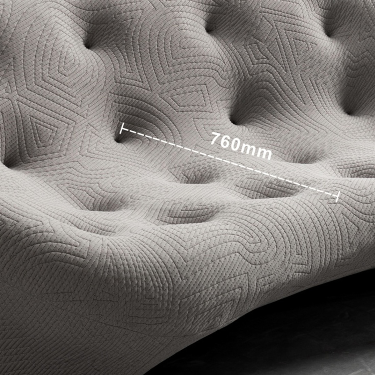 Close-up of grey tufted sofa fabric showing 760mm measurement