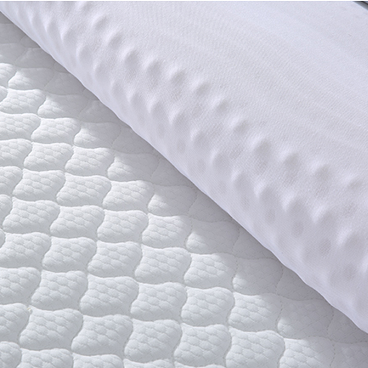 Detail shot of the mattress surface texture and pillow