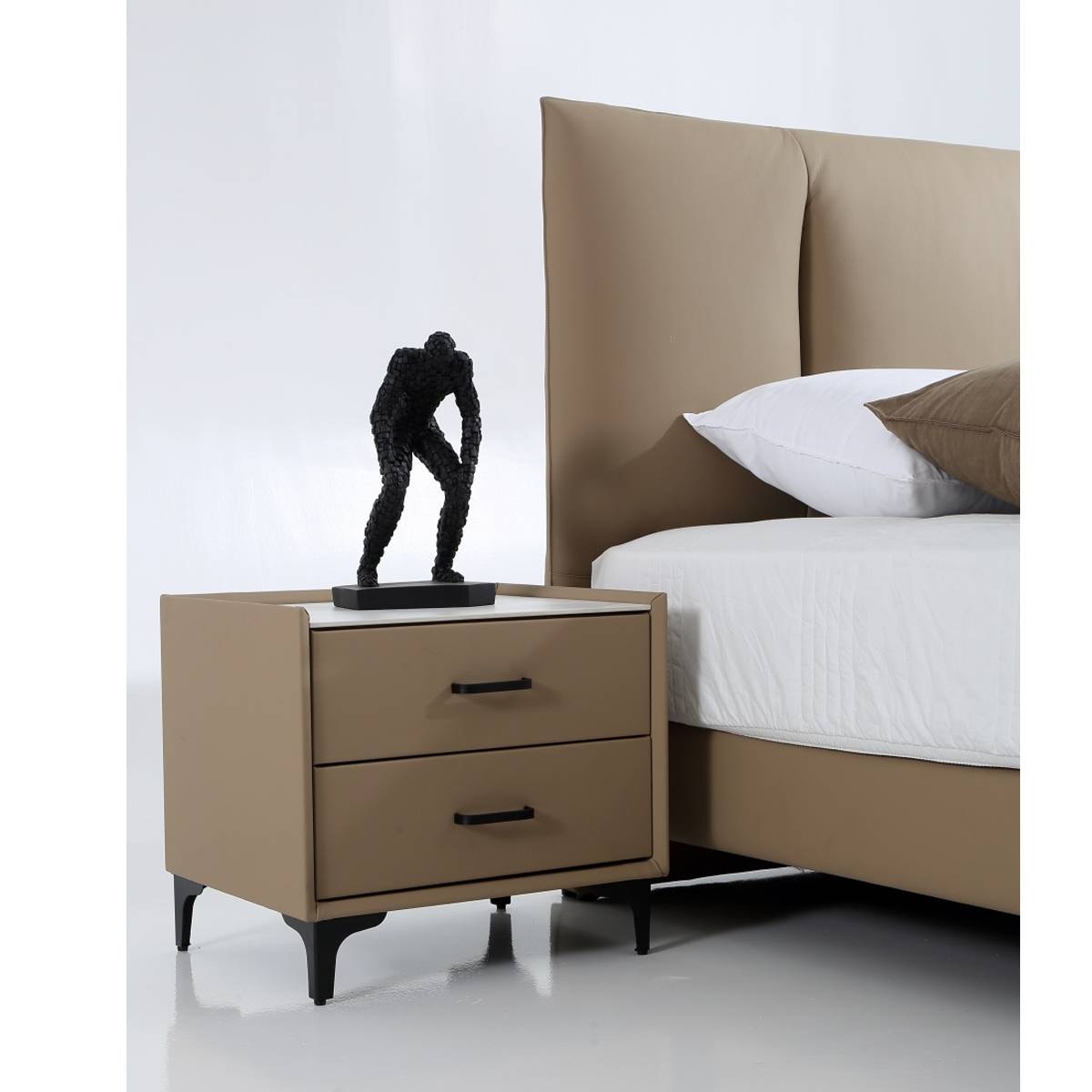 Close-up detail of the bedside table and the leather texture of the bed frame