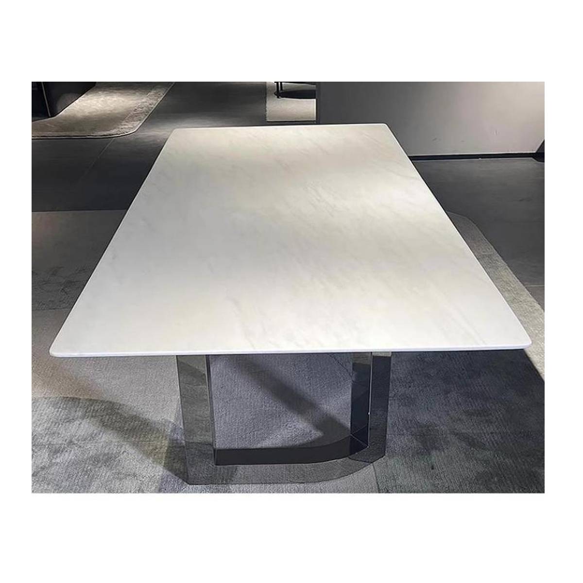 Close-up view of the white marble tabletop and polished metal base