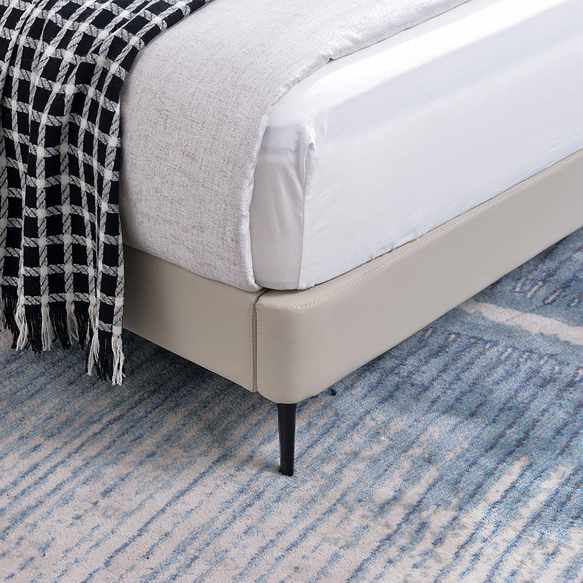 Close-up of the bed base corner and iron leg